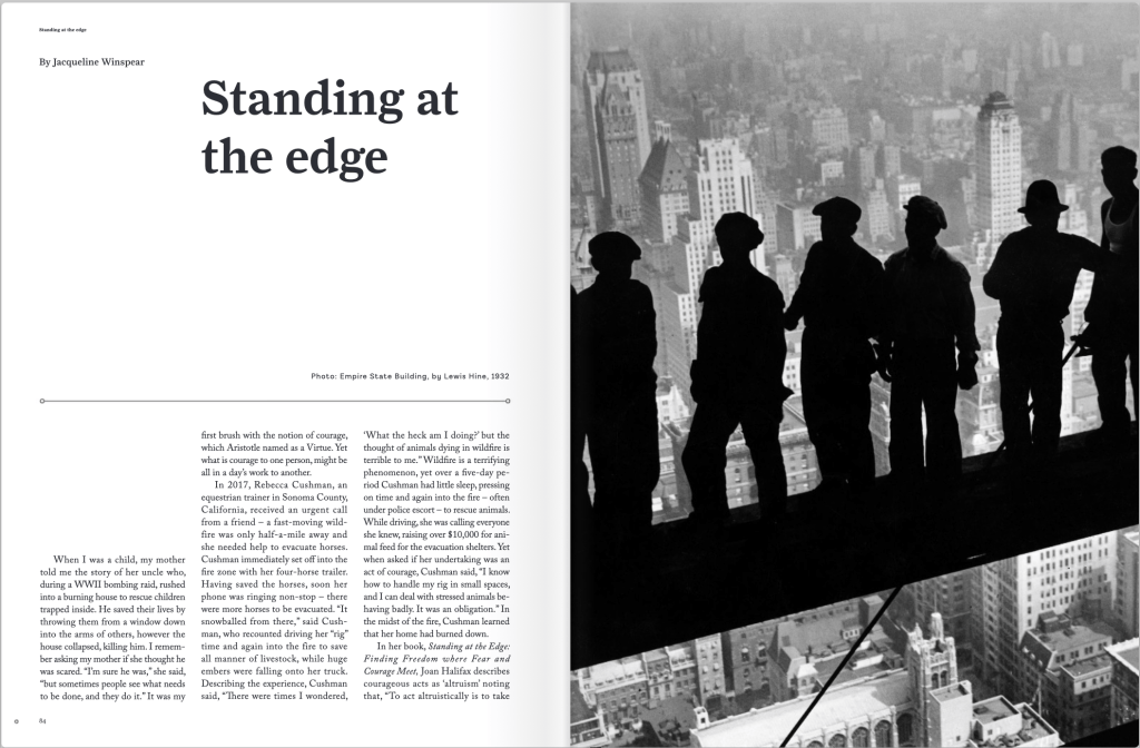 A black and white magazine spread with the words Standing at the Edge and a photograph of human forms against the backdrop of a cityscape.